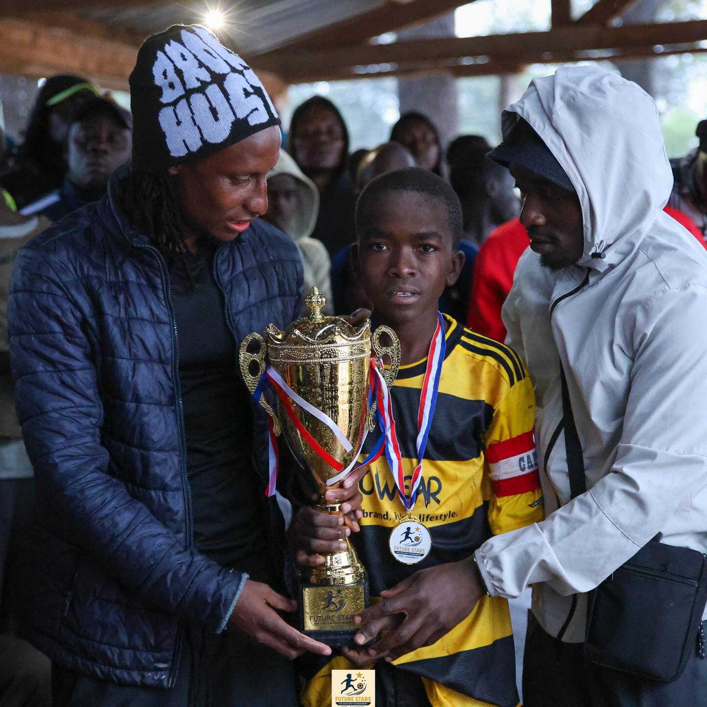Young Santos Soka player holding the Future Stars U12 trophy