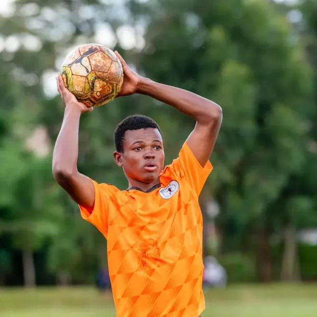 Santos Soka Academy — Goalkeeper taking a throw in the orange kit